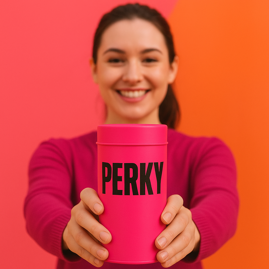 Person holding a pink tin of Perky coffee set against an orange background